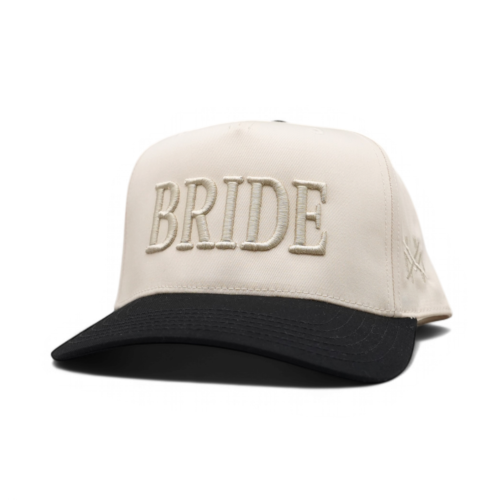 A structured baseball cap with an off-white crown and a black curved brim. The front features the word 'BRIDE' embroidered in large, matching off-white letters, and a small embroidered logo is visible on the side.