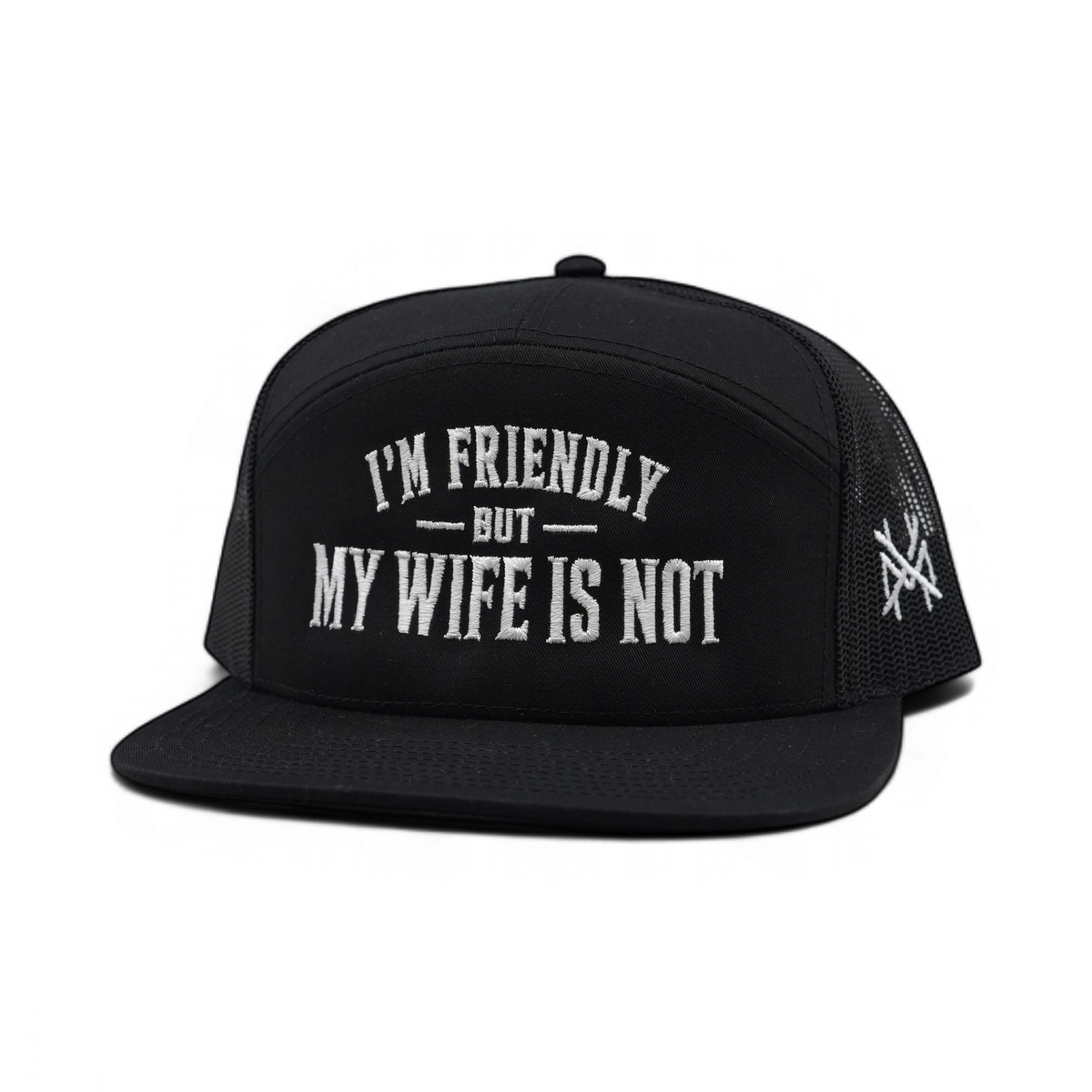 A black trucker hat with white embroidered text reading 'I'M FRIENDLY BUT MY WIFE IS NOT' on the front panel, shown against a plain white background.
