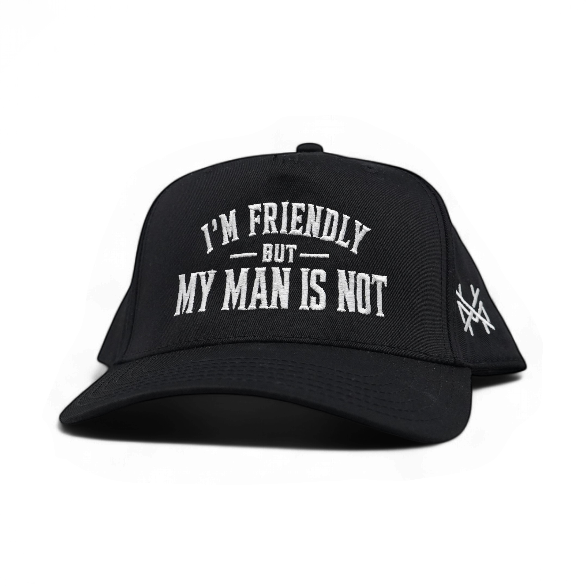 A black baseball cap with white embroidered text reading 'I'M FRIENDLY BUT MY MAN IS NOT' on the front, plus a small white logo on the side, shown on a plain white background.