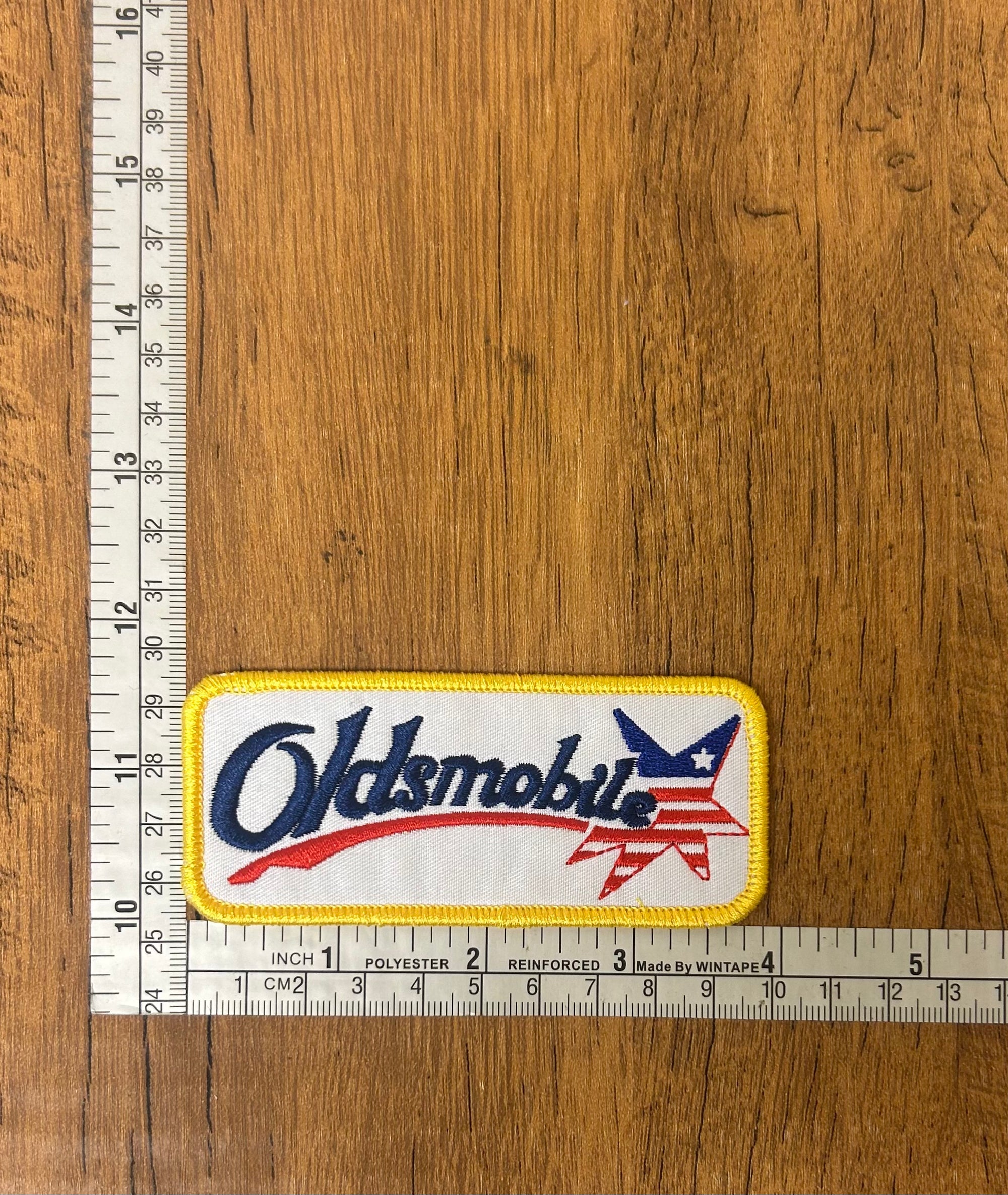 Oldsmobile patch by The Mad Hatter Company, featuring detailed embroidered design for collectible or clothing embellishment.