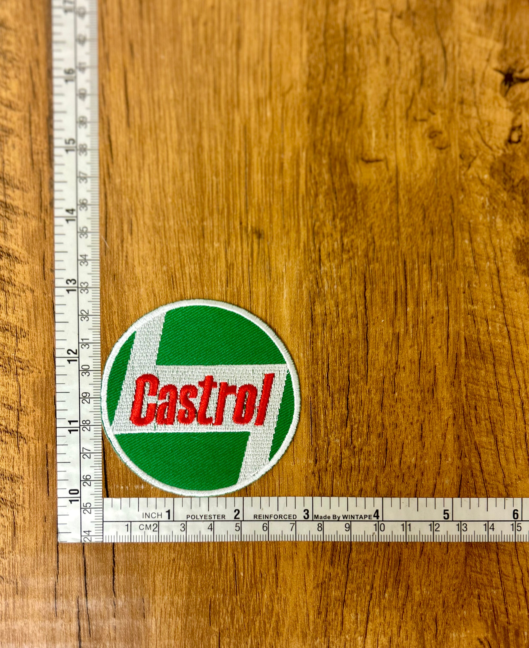 Castrol patch by The Mad Hatter Company featuring a detailed design on fabric for clothing or accessories.