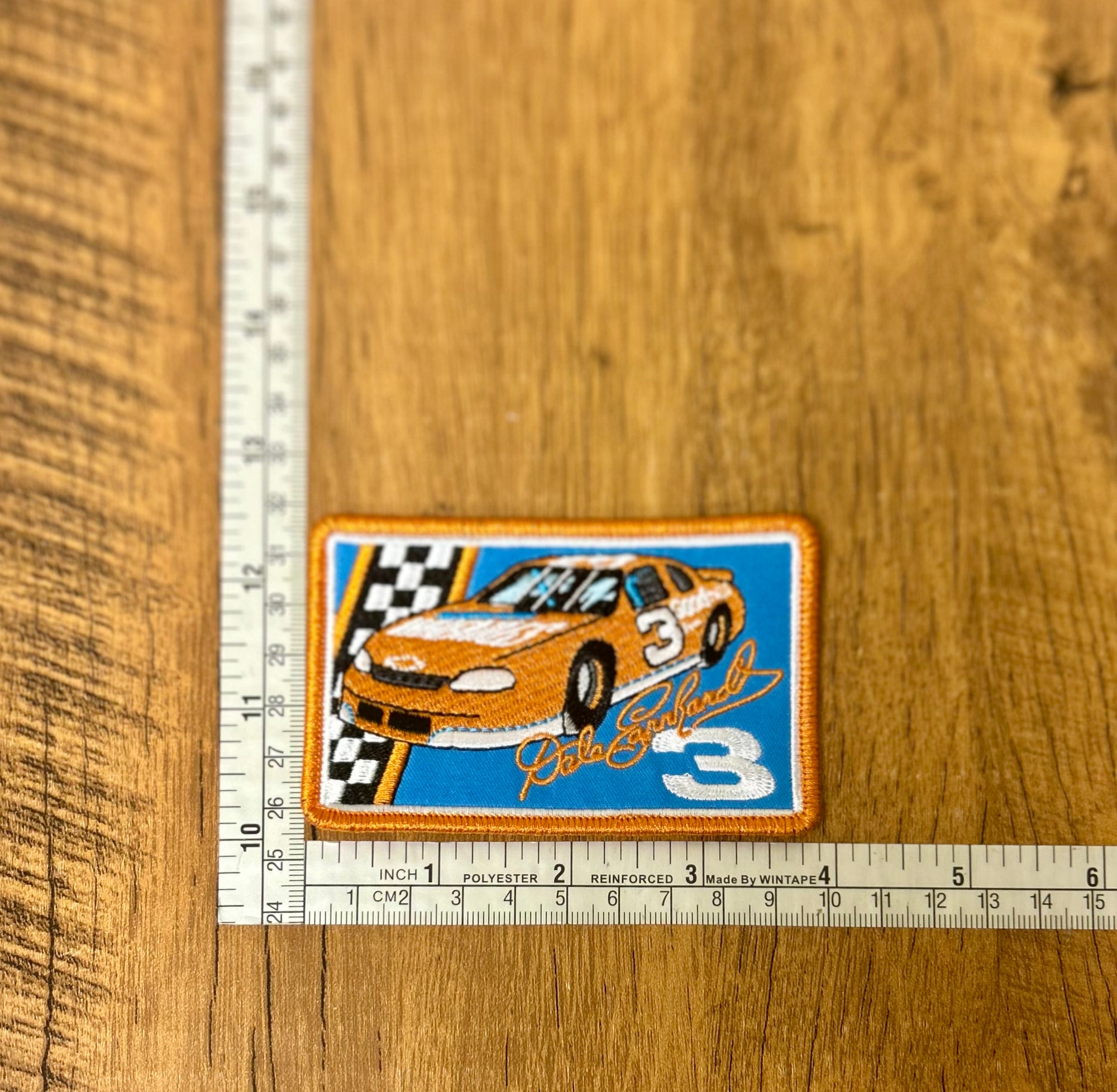 Dale Earnhardt patch by The Mad Hatter Company featuring his racing signature and logo on fabric.