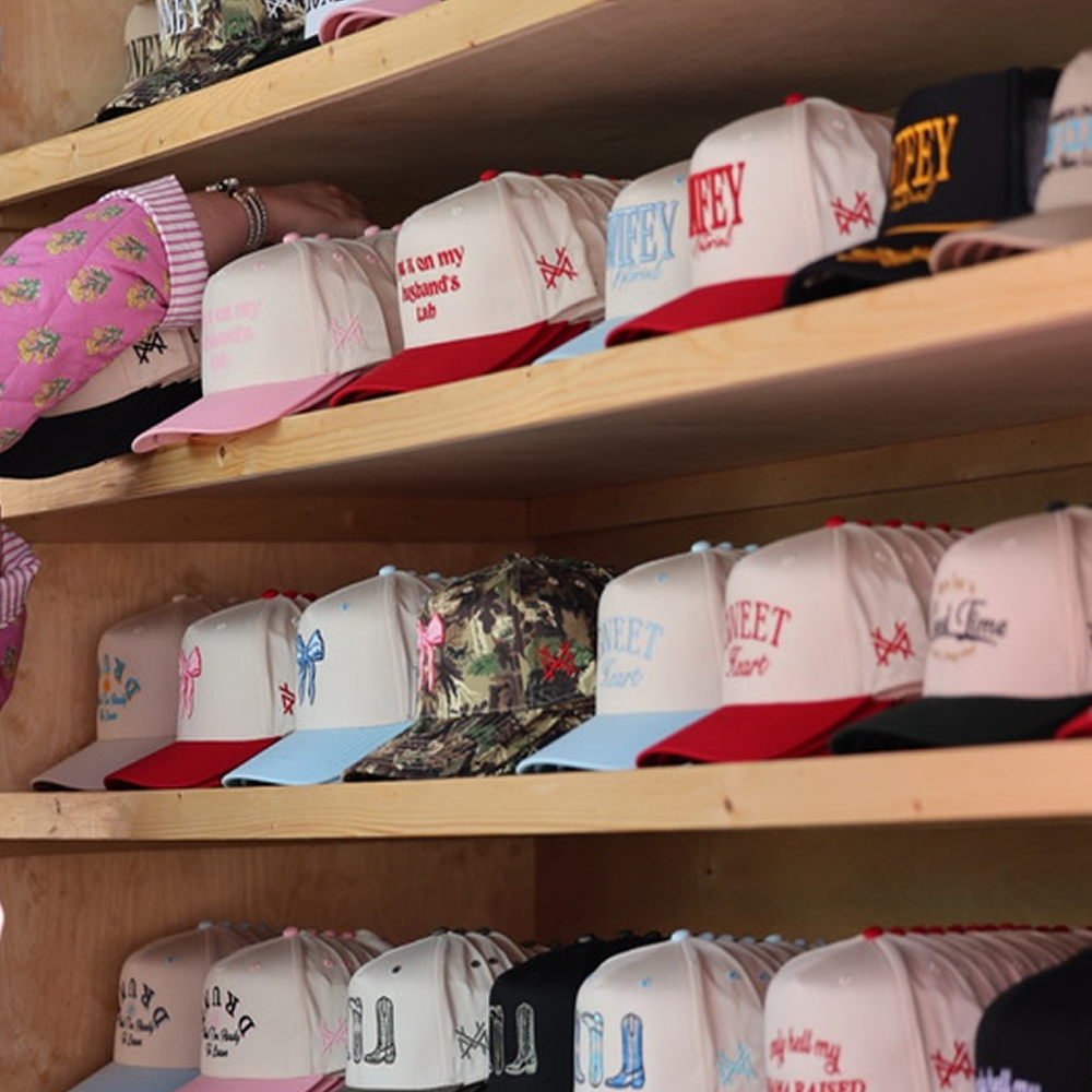 Shelves stocked with Mad Hatter Co. trucker hats